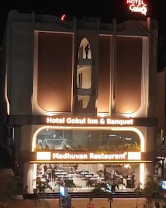 Hotel Gokul Inn and restaurant facade at night