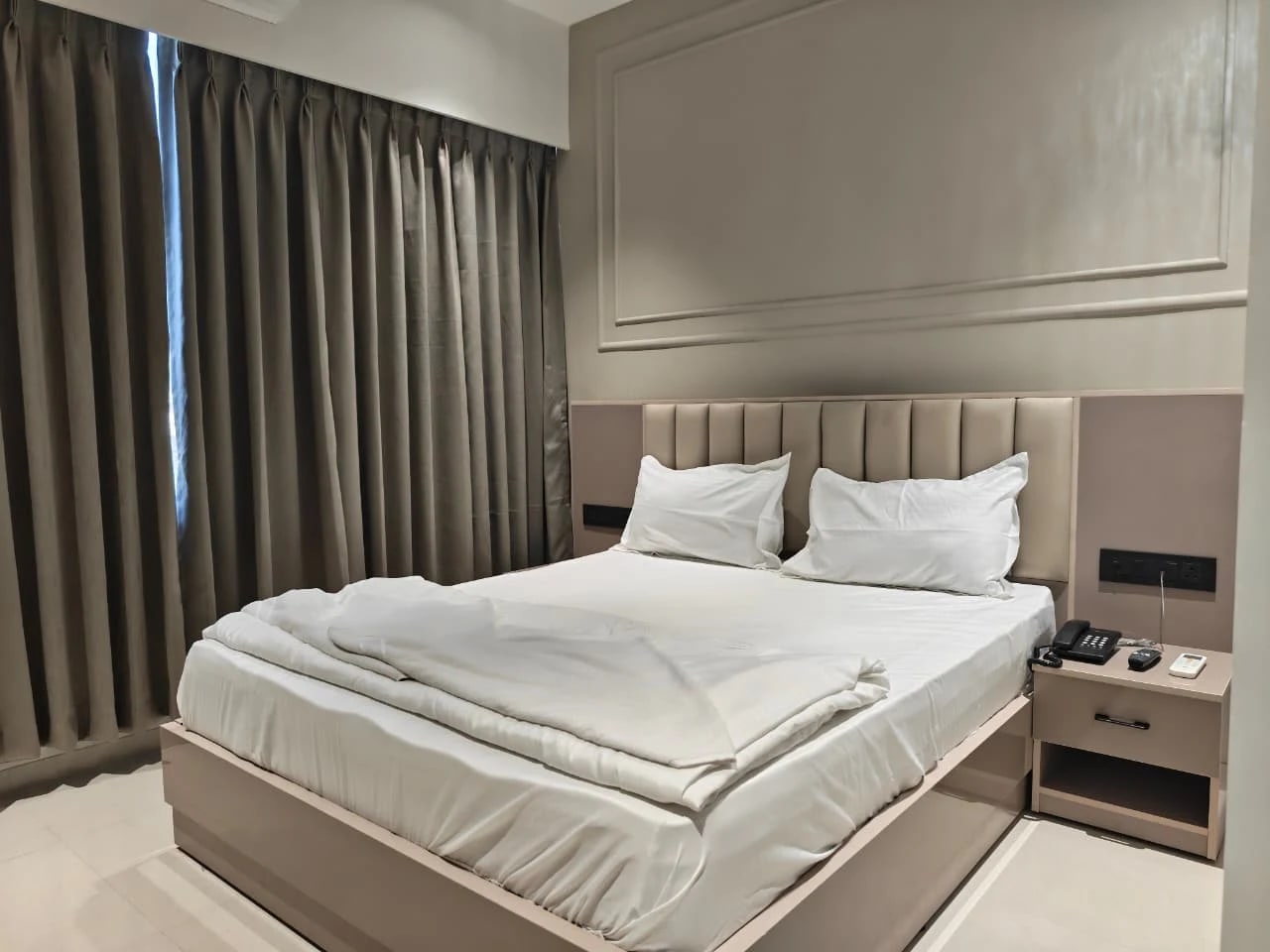 Hotel Gokul Inn room with curtains